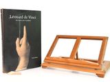 un chevalet en bois sur lequel repose un livre et un autre livre posé sur un support