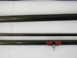 two fishing rods are laying next to each other on a white surface