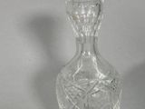 a clear glass bottle with a design on it
