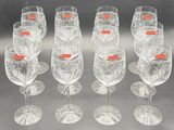 six clear wine glasses are lined up in a row on a table