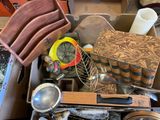 a box full of assorted kitchen items on a table