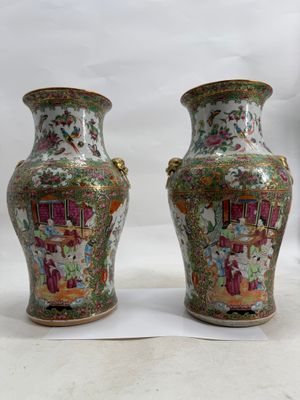 pair of chinese vases on a white surface with a white background