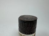 a small black and white container with a chain around it