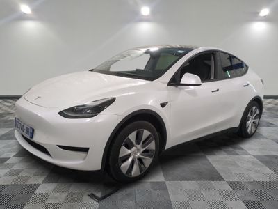 a picture of a white tesla model y in a showroom