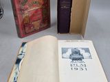 several books are sitting on a table with a clock in the background