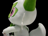 a white stuffed animal with green ears and a green tail