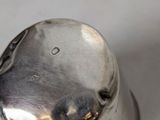a silver salt and pepper shaker sitting on a table
