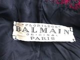 the label on the back of a black and red jacket