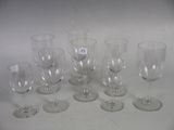 several empty wine glasses sitting on top of a white table