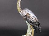 a statue of a bird that is standing on a table
