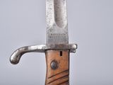 a close up of a knife on a wooden table