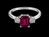 une bague sertie d'une émeraude et de diamants sur fond noir