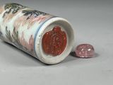 a small vase sitting on a table with a coin next to it