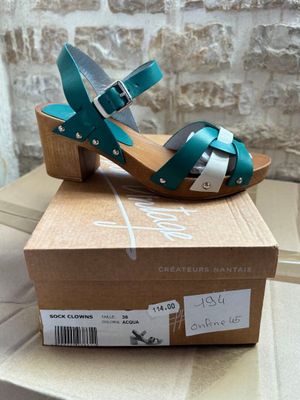 the box is open and has a pair of shoes on top of it