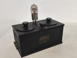 an old fashioned radio is sitting on top of a table
