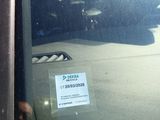 a man that is sitting in a car with a cell phone