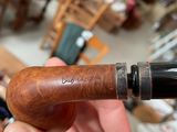 a person holding a pipe in their hand in a room