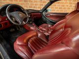 the interior of a car with red leather seats and a steering wheel