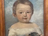 painting of a young boy holding a bunch of grapes in a wooden frame