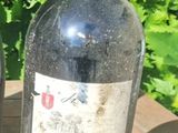 two bottles of wine sitting on a wooden table