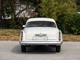 a white car that is parked on the side of the road