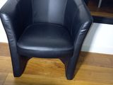 a black chair that is sitting on a wooden floor