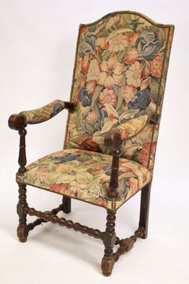 a chair that has a floral upholstered back and arms