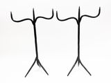 pair of black iron candlesticks on a white background