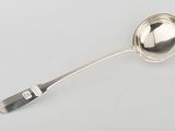 silver plated spoon with handle and spoon rest on a white surface