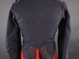 a military jacket with red trims on a mannequin base