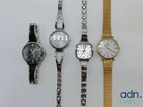 three watches are sitting next to each other on a white surface