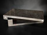 a close up of a concrete table with a black background