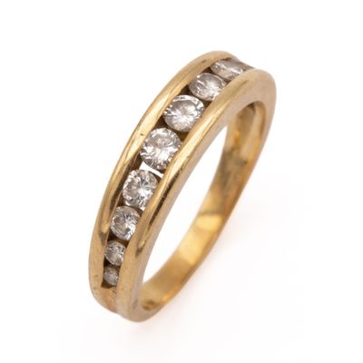 a close up of a gold ring with diamonds on a white background