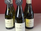 trois bouteilles de vin sont alignées sur un comptoir