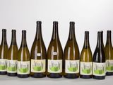 six bottles of wine are lined up in a row on a table
