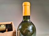 a bottle of wine sitting next to a box of wine