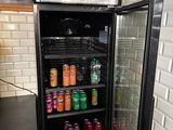 a refrigerator that has a lot of sodas in it