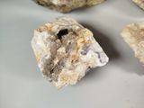 three pieces of rock on a white surface
