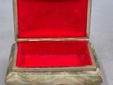 an antique gold and red box with red velvet inside