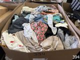 a cardboard box full of clothes on a table