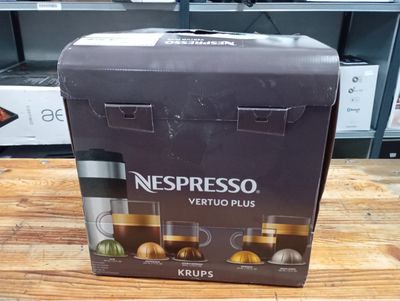 a box of nespresso vertuo plus coffee machines on a table