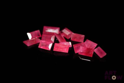 some very pretty pink diamonds on a black surface