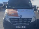 the front of a white van parked in a parking lot