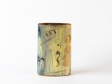 a small vase with a painting on it on a white surface