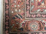 an antique persian rug with a floral design and fringes