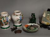 four vases sitting on a table next to a plate