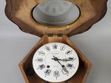 a small wooden box with a clock inside of it