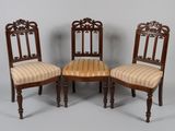 three antique chairs with striped upholstered seats and wooden legs