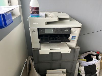a printer that is sitting on top of a stack of boxes