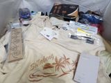many items that are sitting on a bed in a box